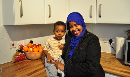 Khandra Khalif and her son Muad in the kitchen of their new house